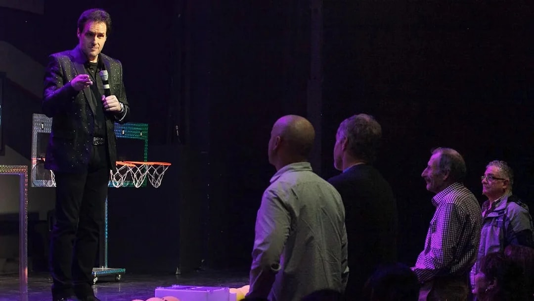 Performer engaging audience during The Mentalist show.