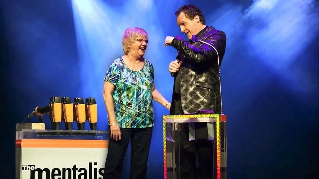 Performer interacting with audience member during The Mentalist show.