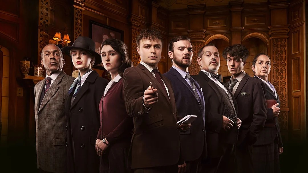 Cast of "The Mousetrap" in period costumes on stage.