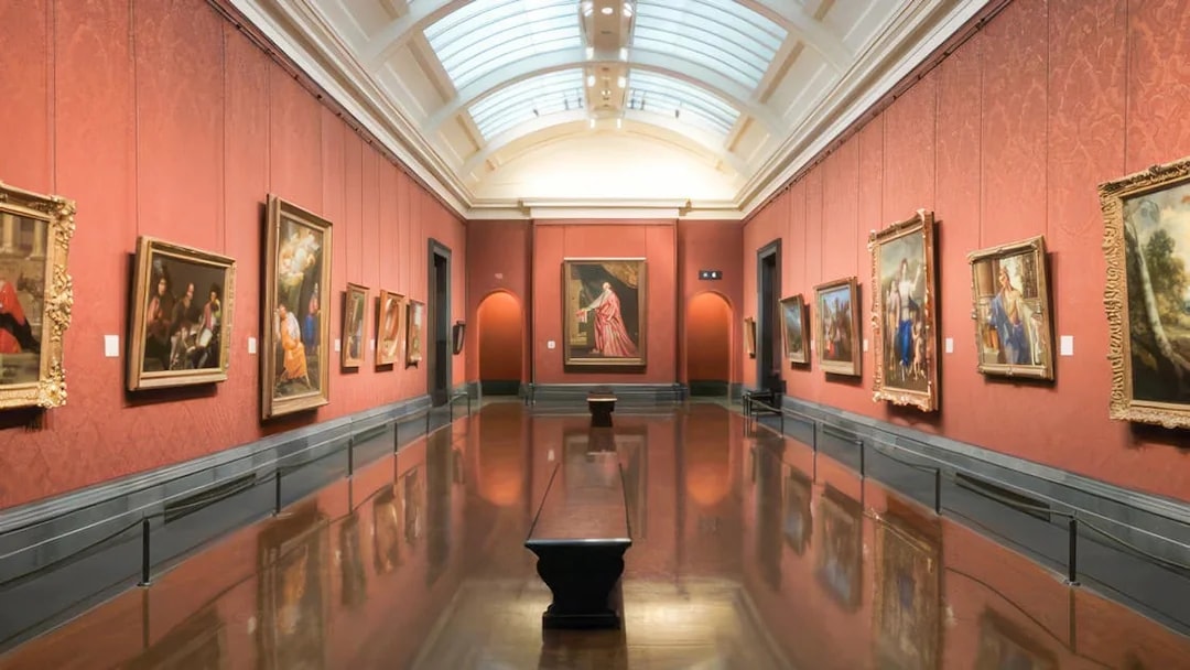 Interior of a gallery room with classic paintings at the National Gallery, London.