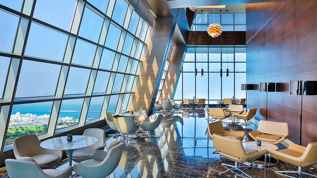 Observation Deck at 300, Etihad Tower, Abu Dhabi with city and sea view through large windows.