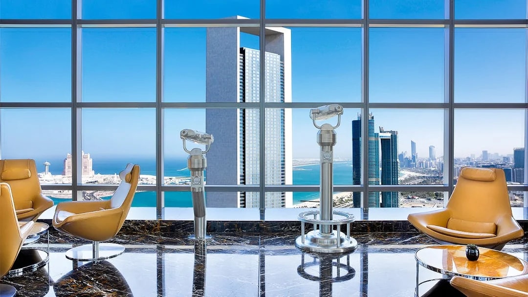 Observation deck view from 300 Etihad Tower, Abu Dhabi, with city skyline and telescopes.