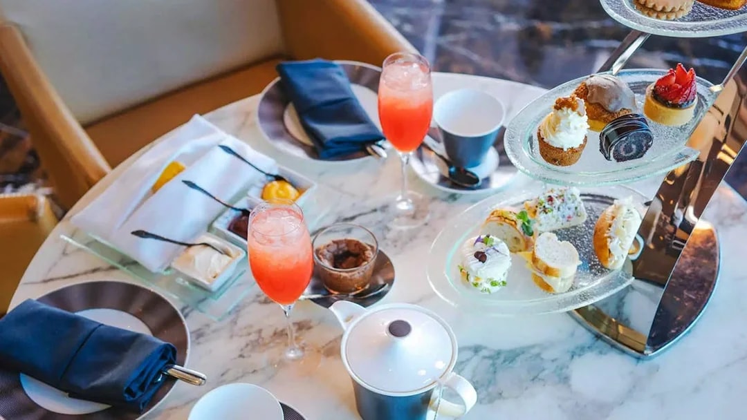 Afternoon tea with pastries and drinks at The Observation Deck at 300, Etihad Tower, Abu Dhabi.