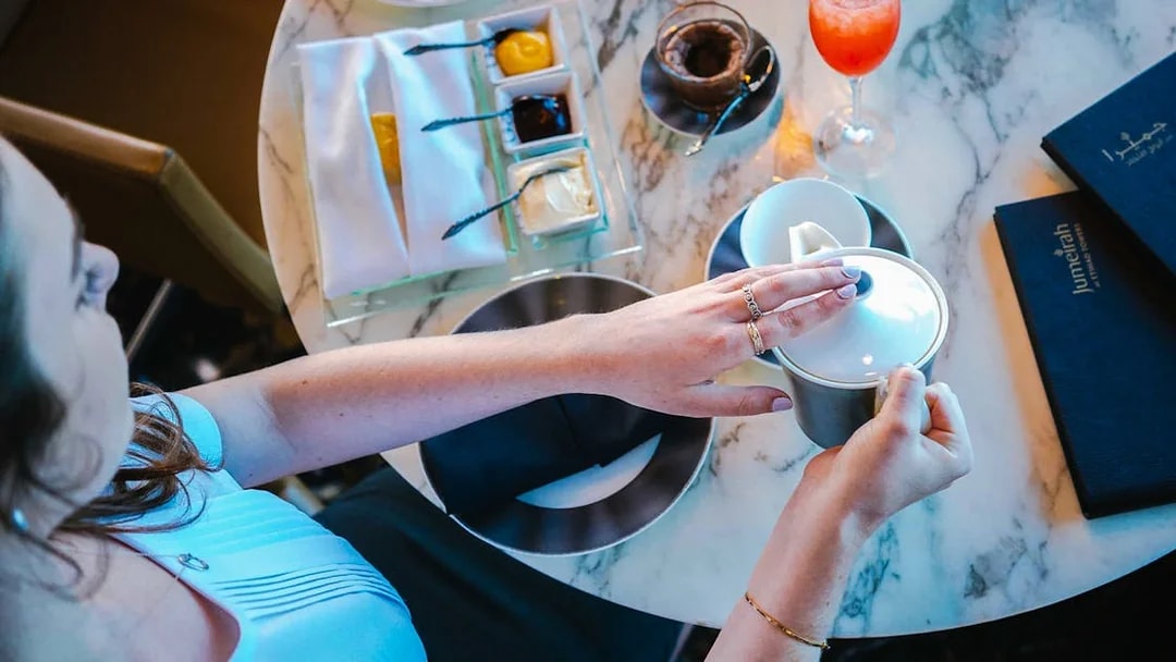 Dining experience at Observation Deck at 300, Etihad Tower, Abu Dhabi with tea and desserts.