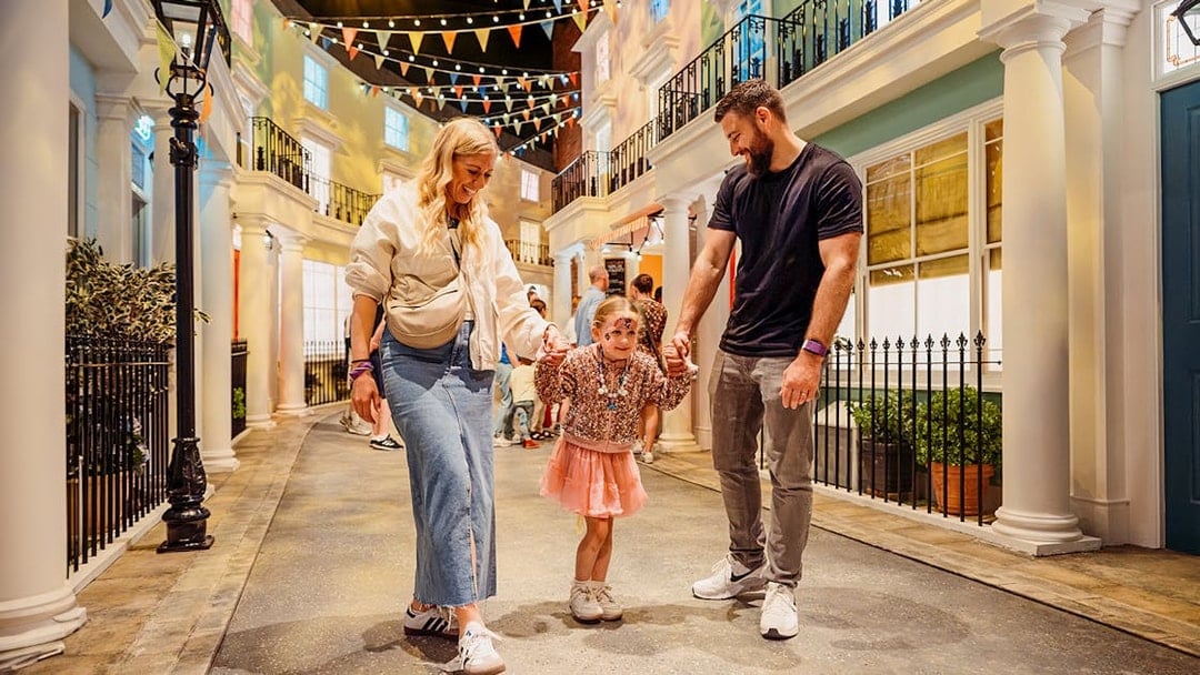Children with parents enjoying The Paddington Bear Experience in London.
