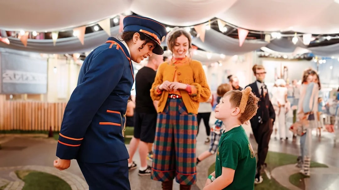 Guests interacting with staff at the Paddington Bear experience in London, a family-friendly tour.