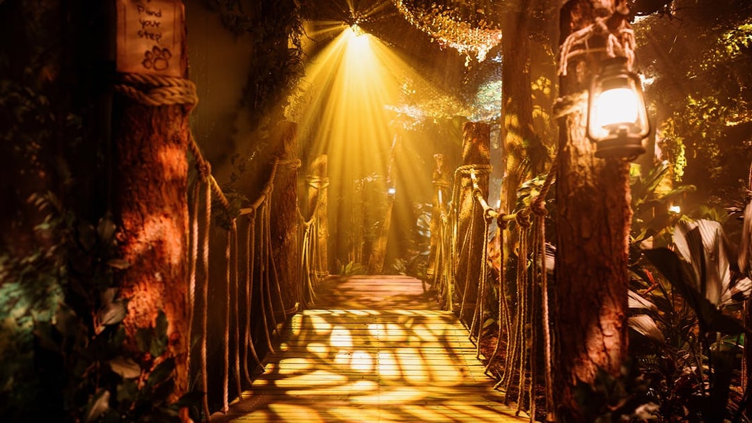 Rope bridge with lanterns and foliage at Peru setup, Paddington Experience.
