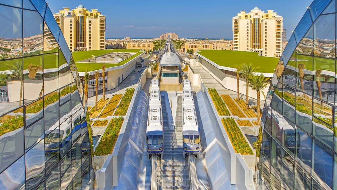 Palm Jumeirah Monorail near station with modern architecture and cityscape.