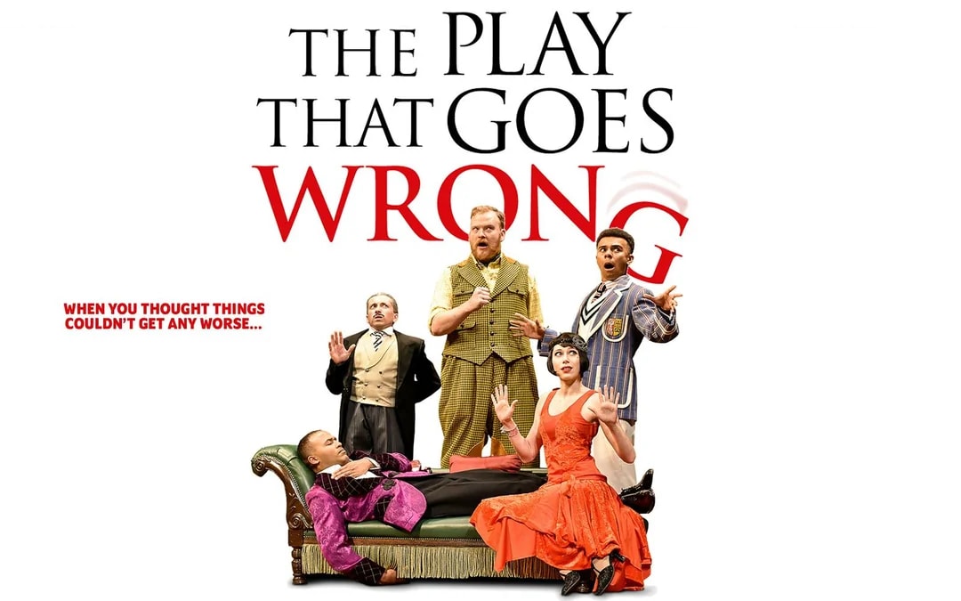 Cast of "The Play That Goes Wrong" in comedic poses on stage.