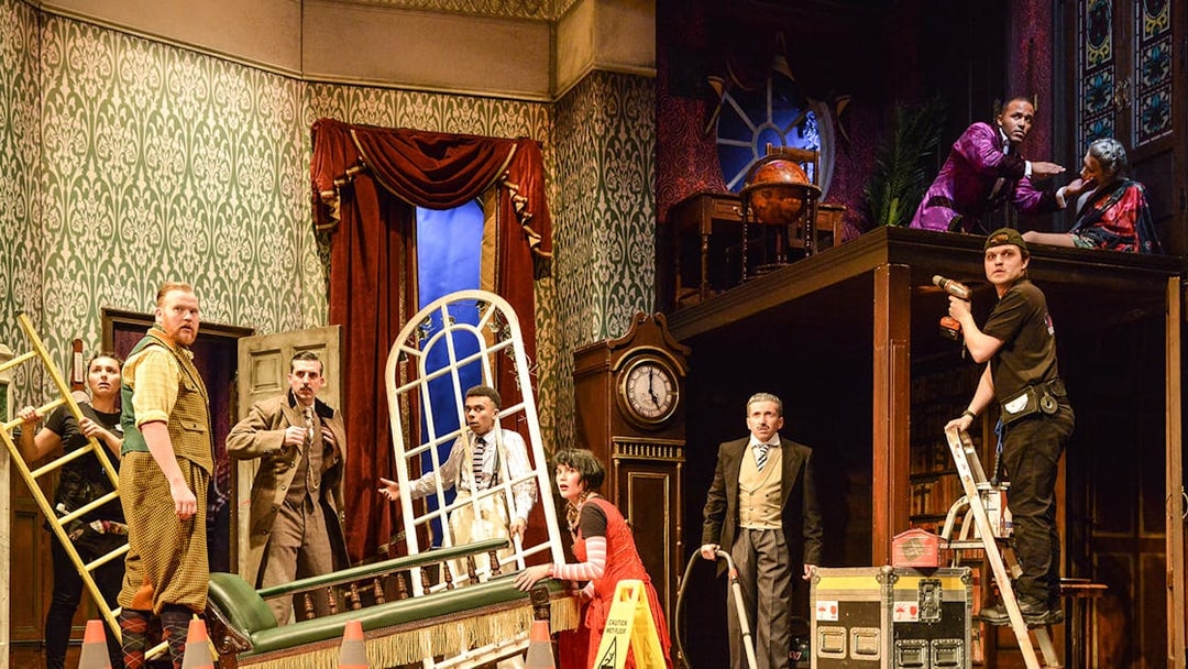 Cast members on stage during a chaotic scene from "The Play That Goes Wrong.