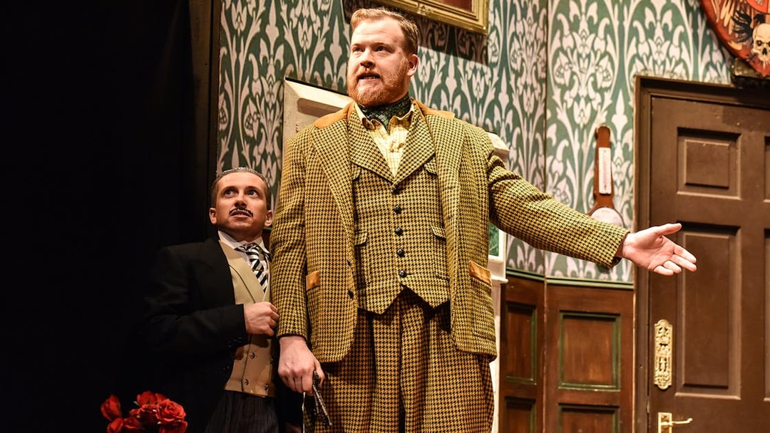 Actors performing a scene from "The Play That Goes Wrong" on stage.