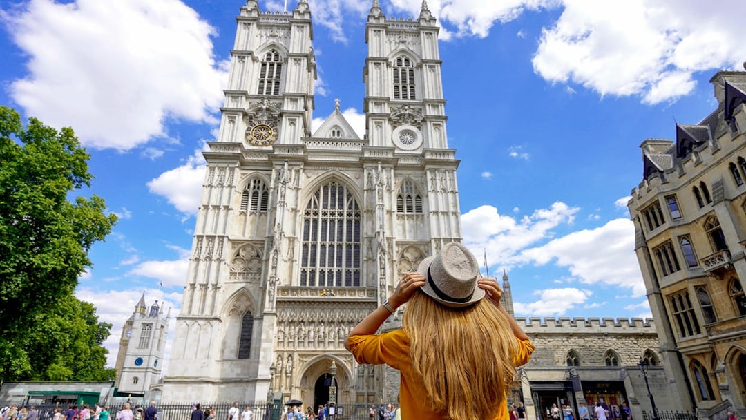 Westminster Abbey facade with visitor during 3-hour walking tour, London.