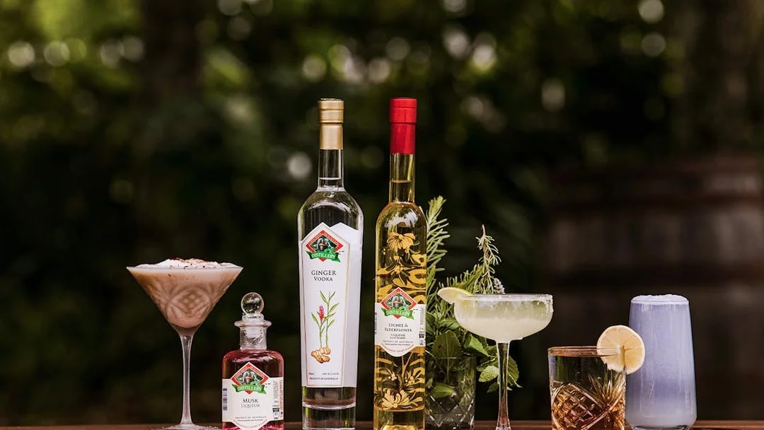 Assorted drinks and spirits from Tamborine Mountain distillery on a wooden table.