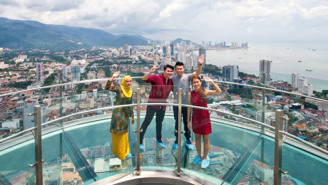 Visitors enjoying the view from Rainbow Skywalk and Observatory Deck in Penang, Malaysia.