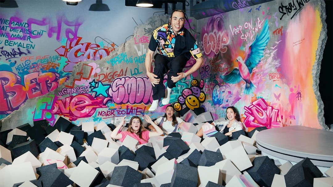Visitors enjoying foam pit and graffiti art at The Upside Down Berlin.