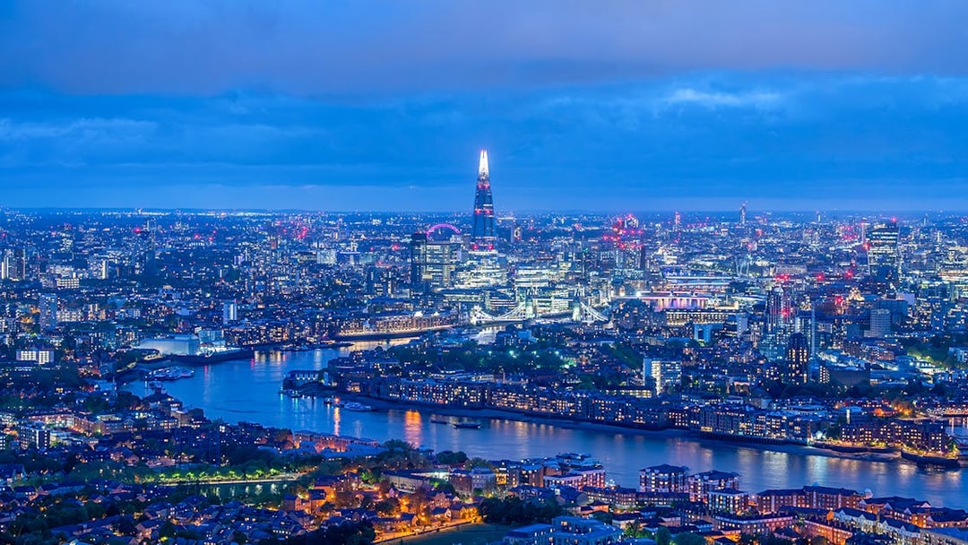 London skyline at night with The Shard and River Thames.
