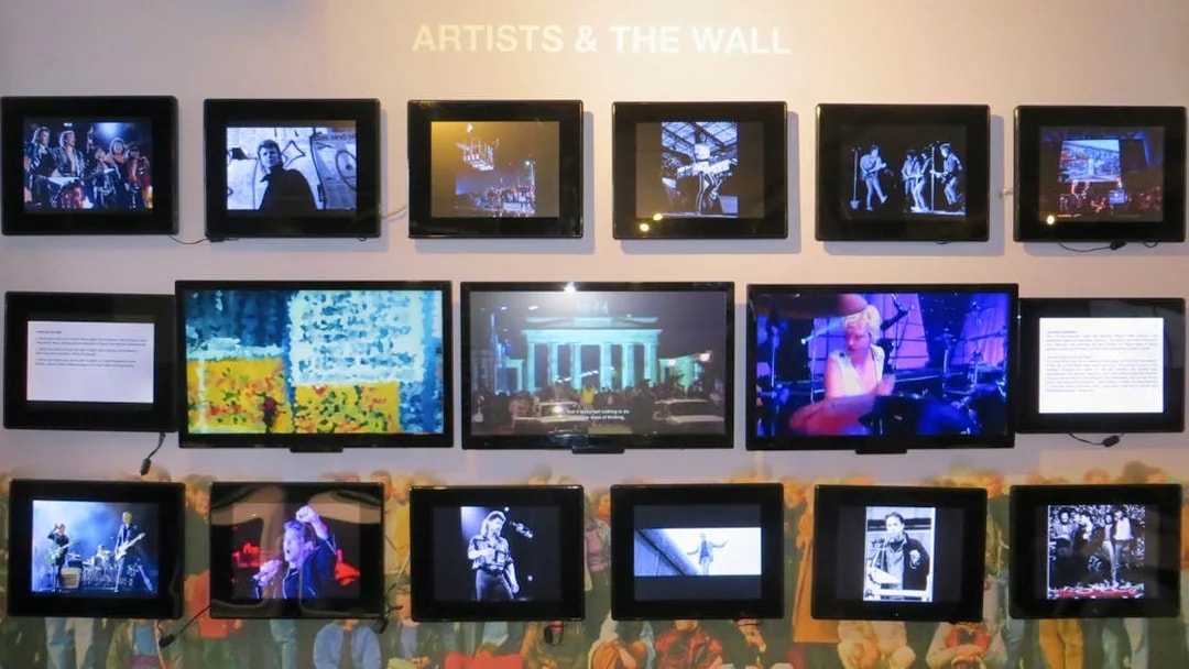 Wall Museum East Side Gallery exhibit featuring multimedia displays of artists and Berlin Wall history.