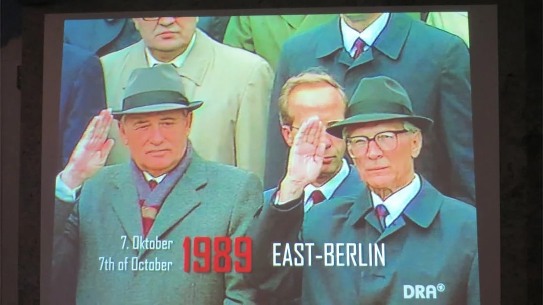 Historical leaders saluting in East Berlin, 1989, at The Wall Museum East Side Gallery.