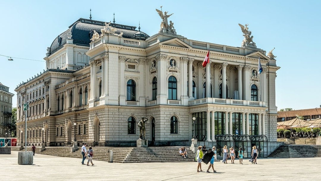 Zurich Opera House with visitors in the plaza, part of The ZURICH Experience Tour.