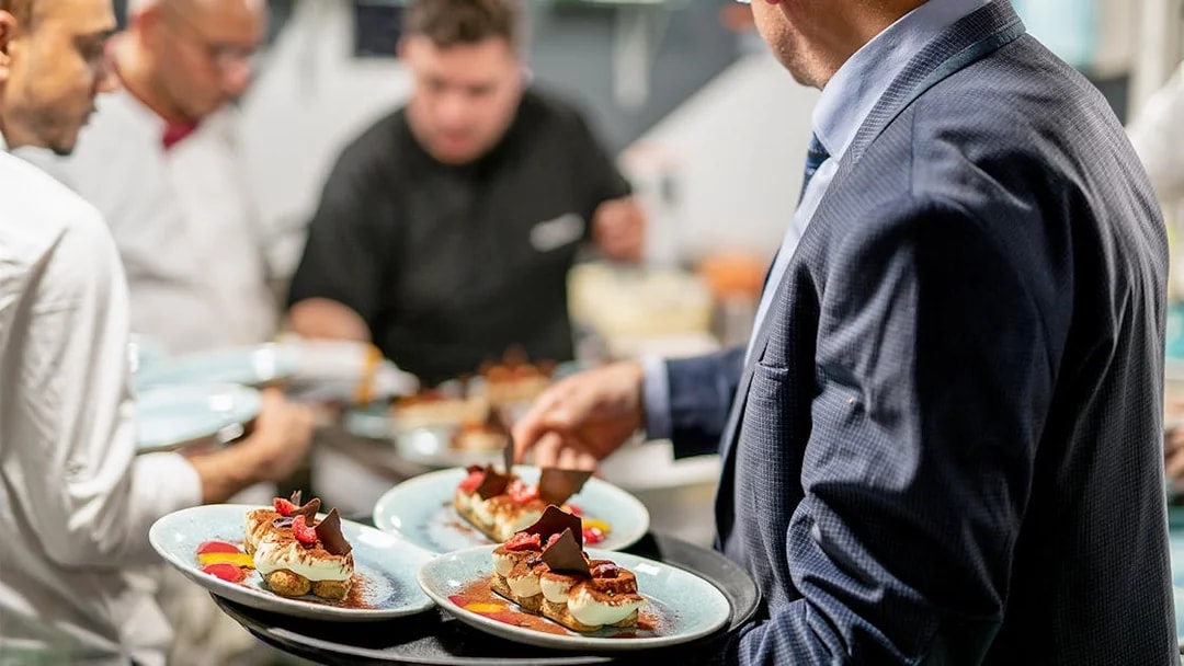 Servers preparing Italian desserts on Le Diamant Bleu dinner cruise in Paris.
