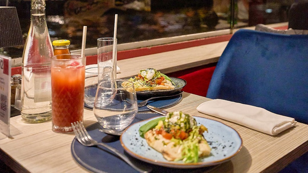 Dinner table with Italian dishes on the Théo Boat Seine River Cruise in Paris.