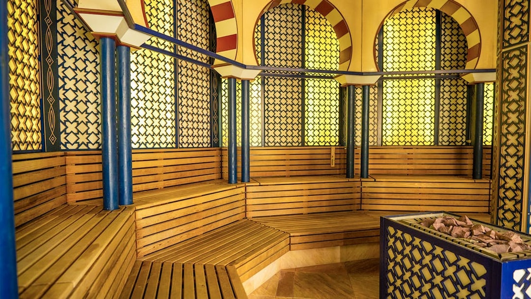 Therme Bucuresti sauna interior with wooden benches and decorative walls.