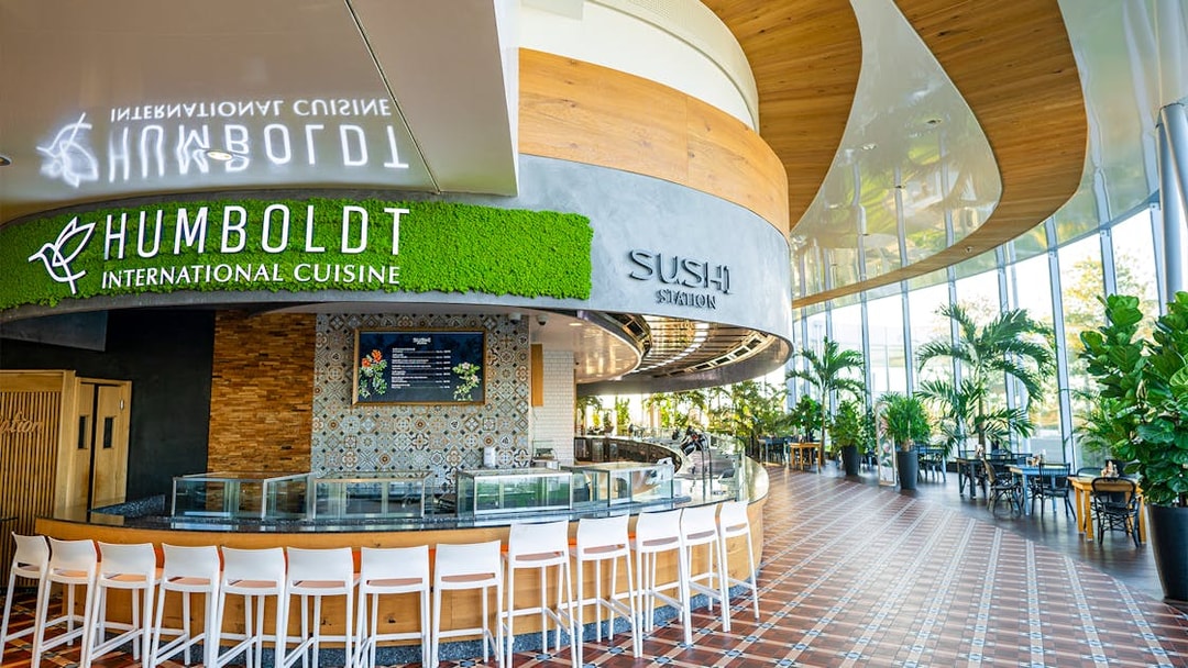 Sushi restaurant interior at Therme Bucuresti with seating and greenery.