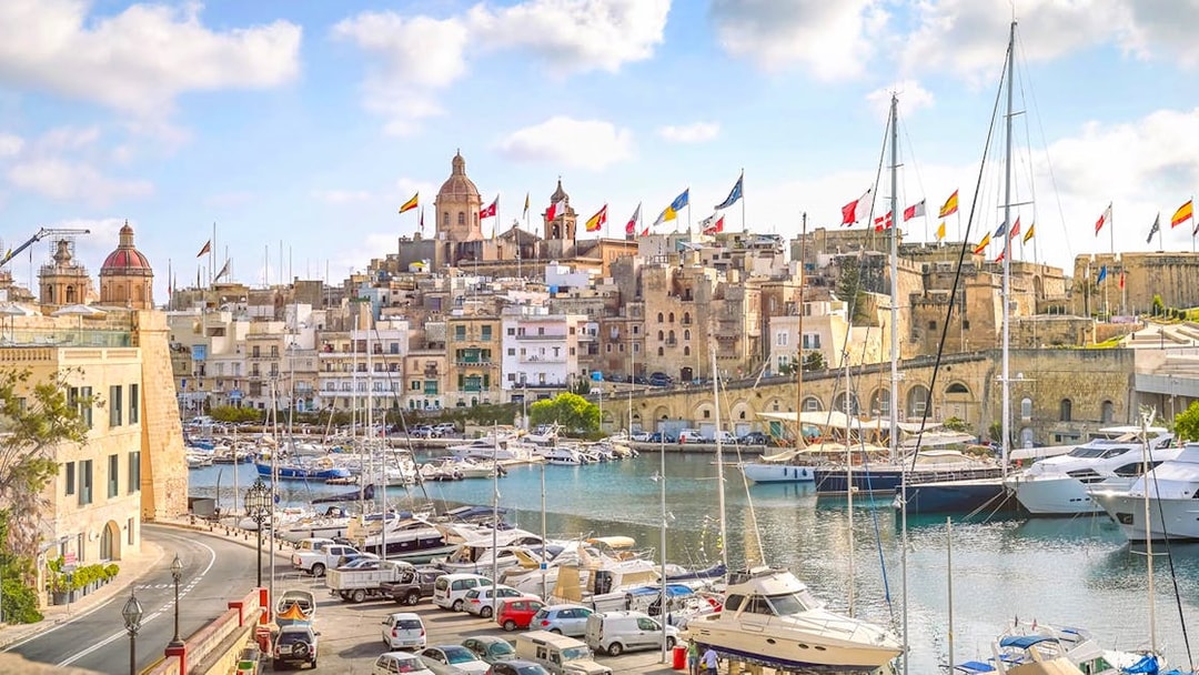 Harbor view of The Three Fortified Cities with boats and historic buildings in Malta.