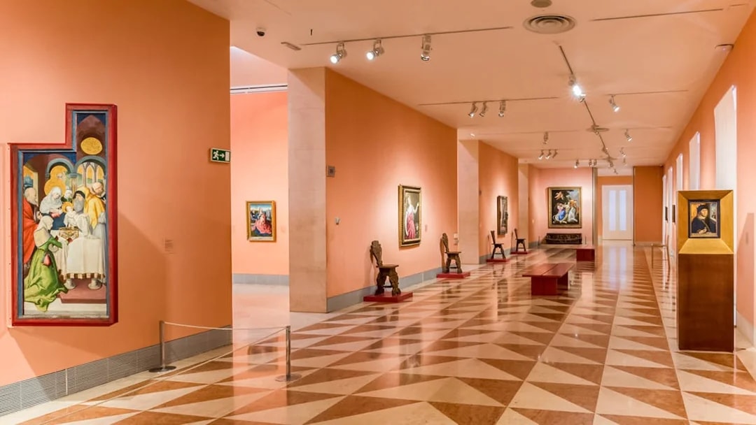 Thyssen Bornemisza Museum gallery room with paintings on display in Madrid.