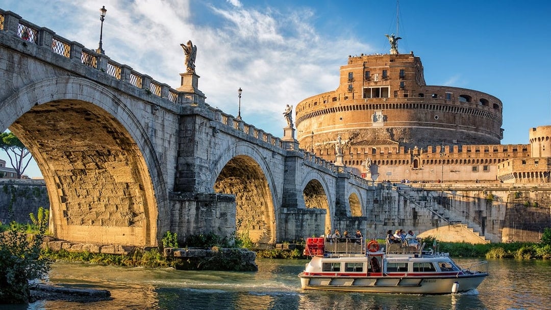 Cruise boat on the Tiber River near Castel Sant'Angelo, Rome.