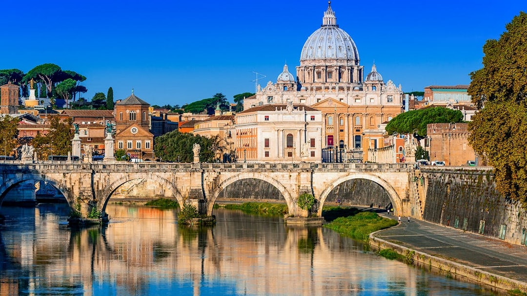 St. Peter's Basilica and Sant'Angelo Bridge over the Tiber River in Rome.