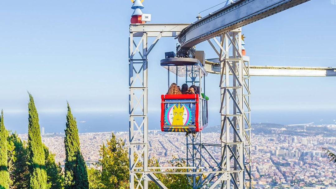 Tibidabo amusement park ride with city view in Barcelona.