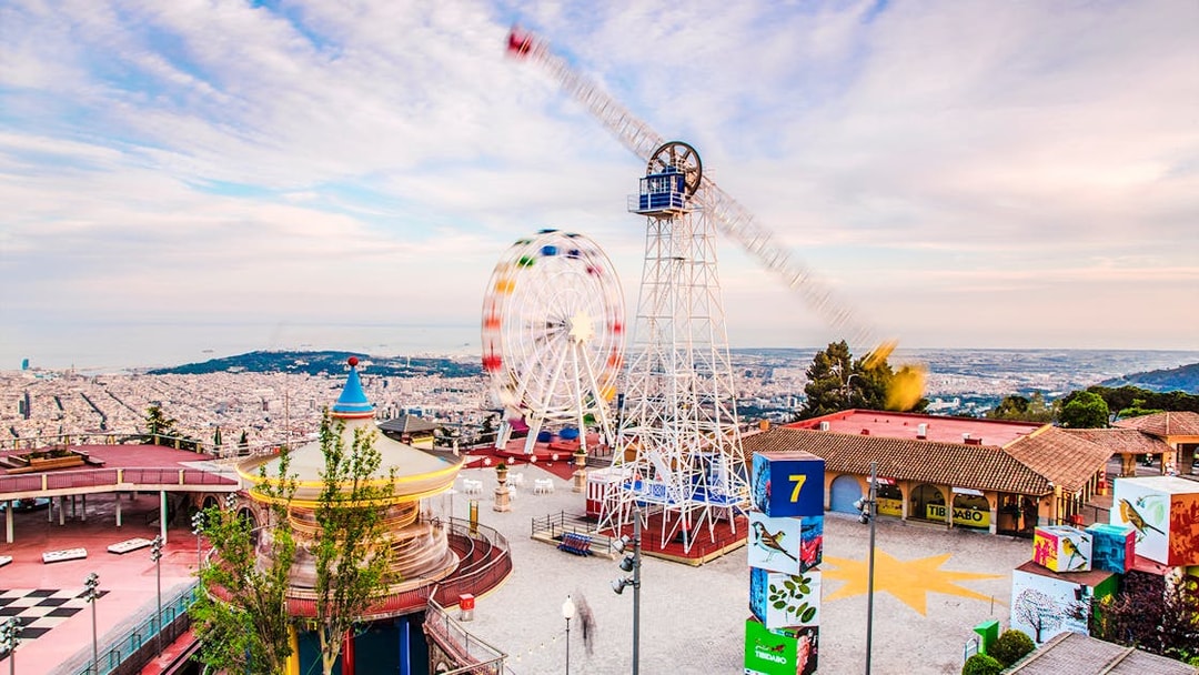 Tibidabo Amusement Park with Ferris wheel and panoramic view of Barcelona.