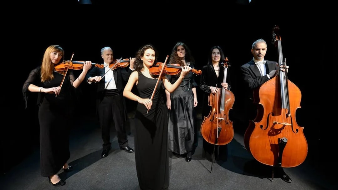 Orchestra performing on stage during the Opera at Night Experience.
