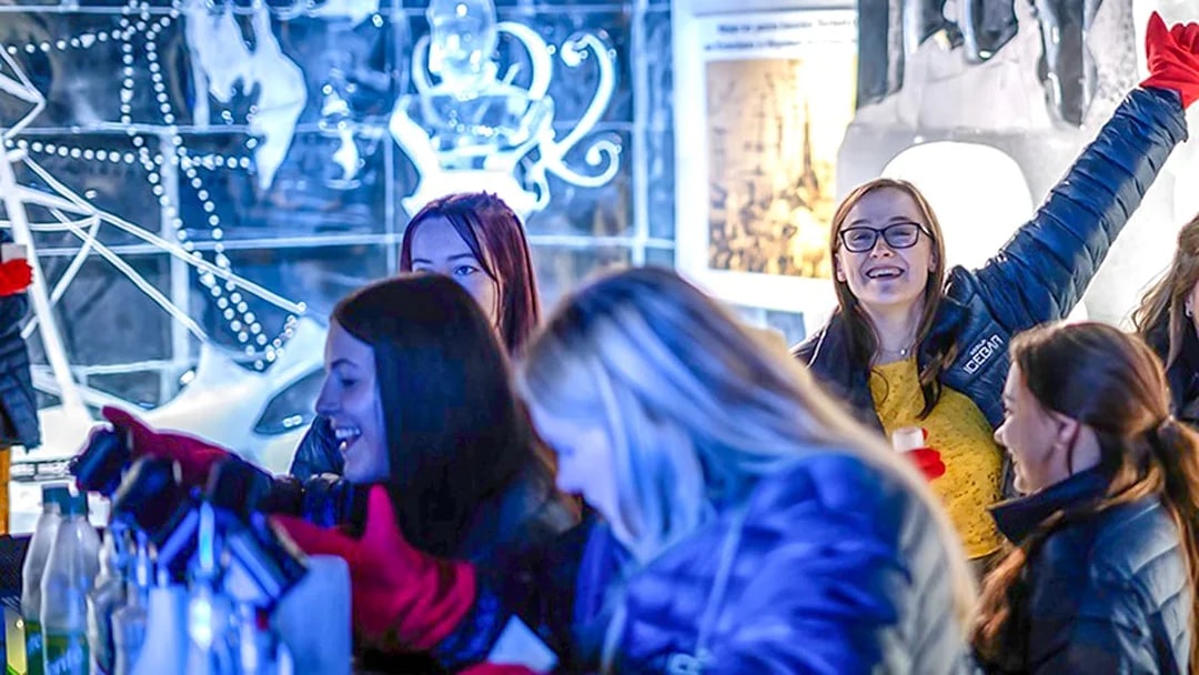 Guests having fun at the Berlin Icebar with ice sculptures in the background.
