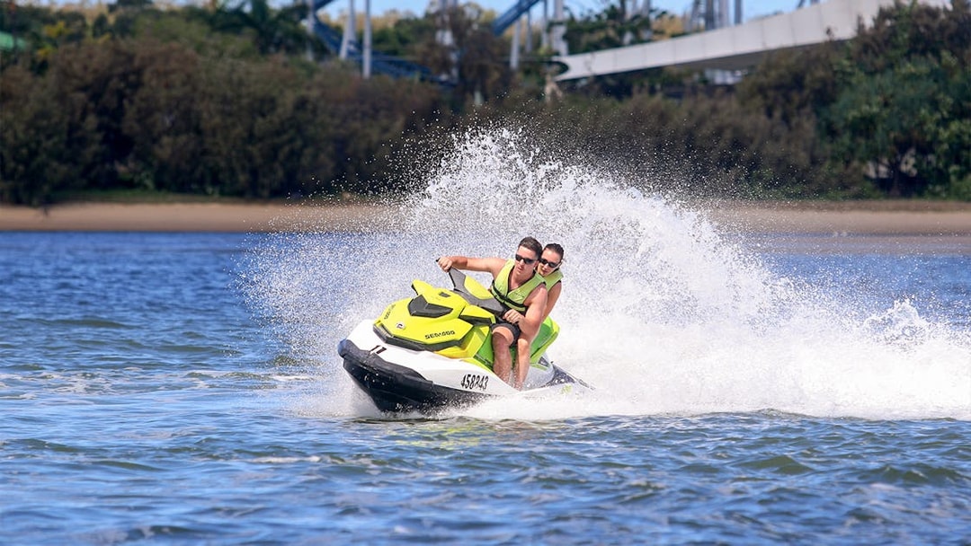 Jet ski riders speeding on water during a Jet Ski & Parasail Experience.