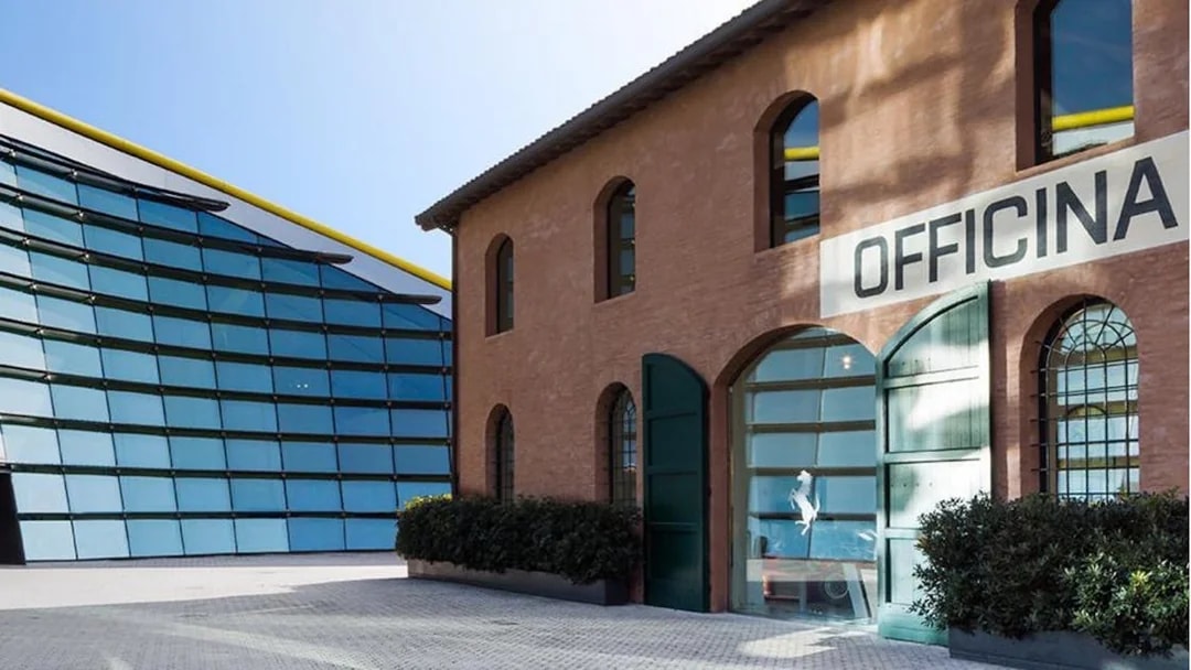 Museo Enzo Ferrari Modena entrance with modern glass building and historic brick structure.