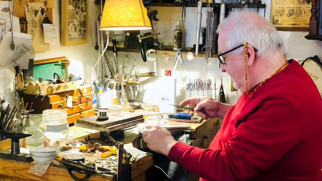 Craftsman working on amber jewelry at a workshop in Gdańsk.