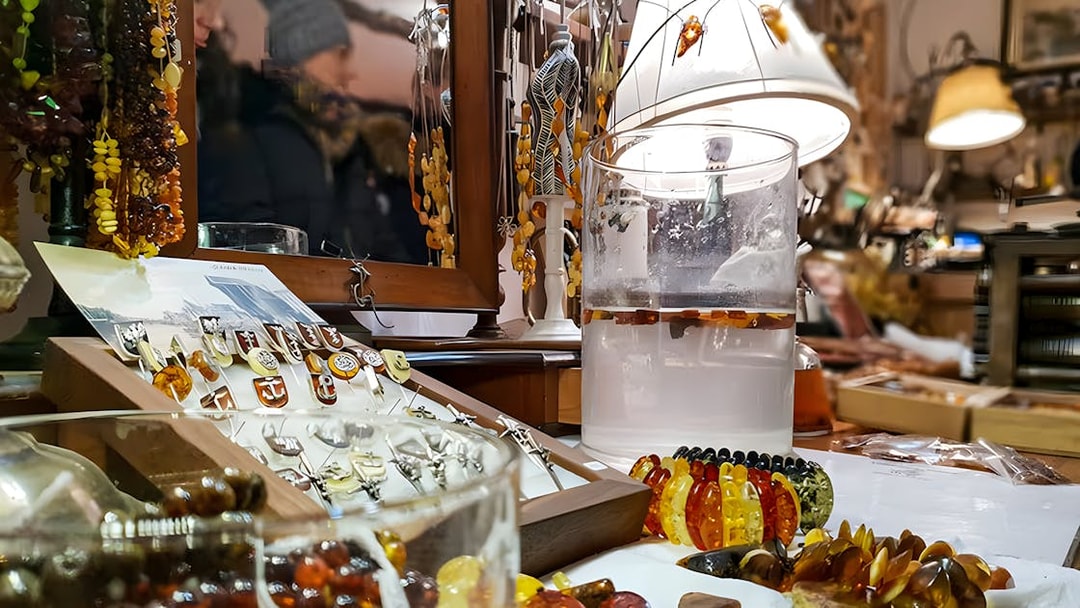 Amber jewelry display at Gdańsk workshop with necklaces and rings.