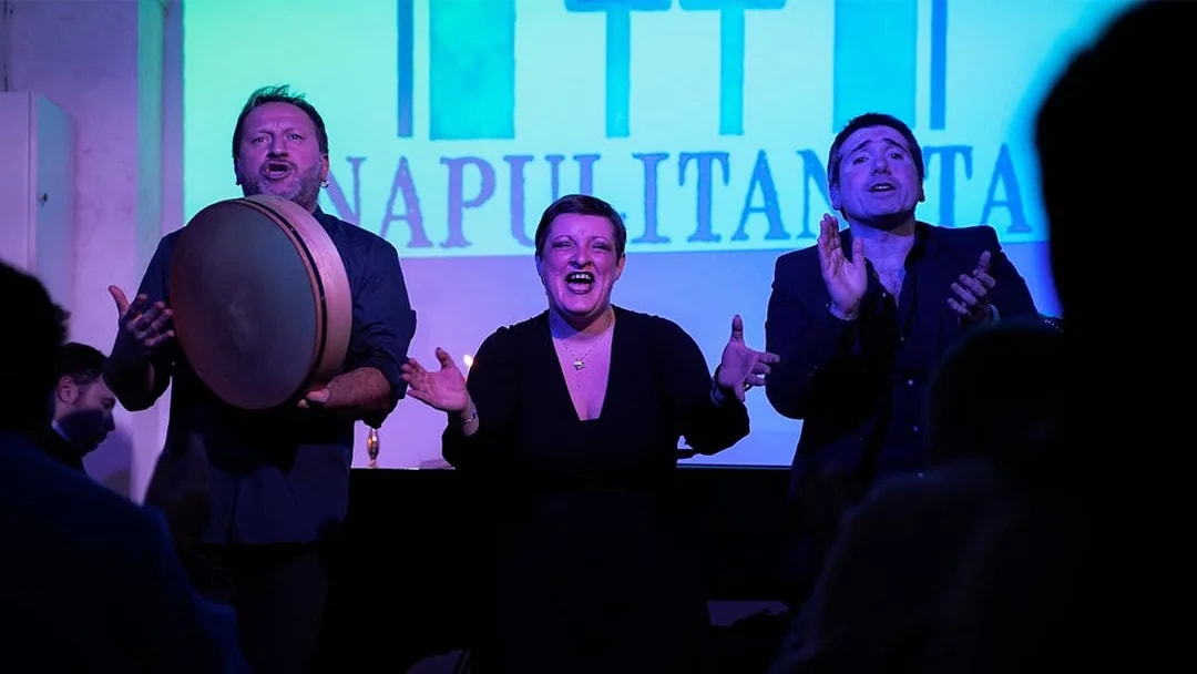 Performers singing at a traditional Neapolitan music concert in Naples.
