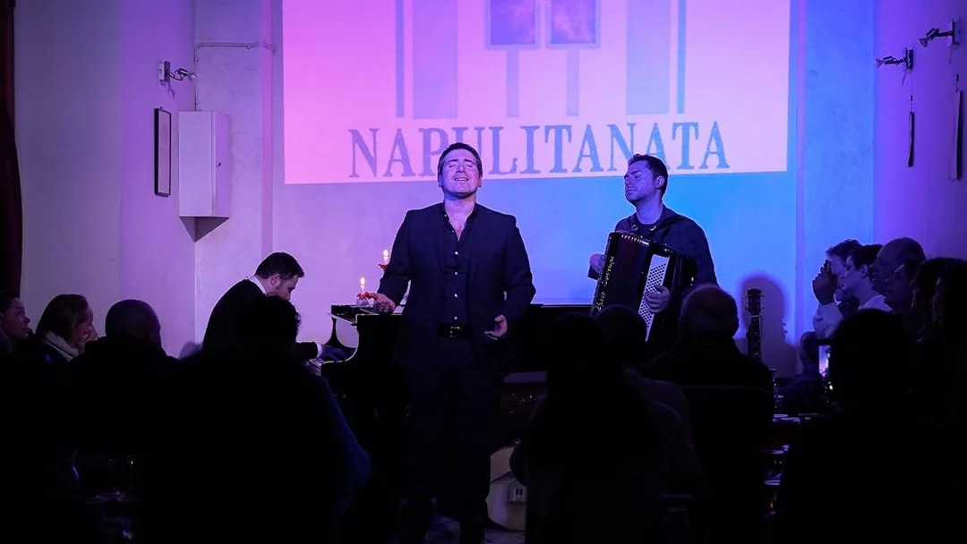 Singer and accordionist performing at a traditional Neapolitan music concert in Naples.