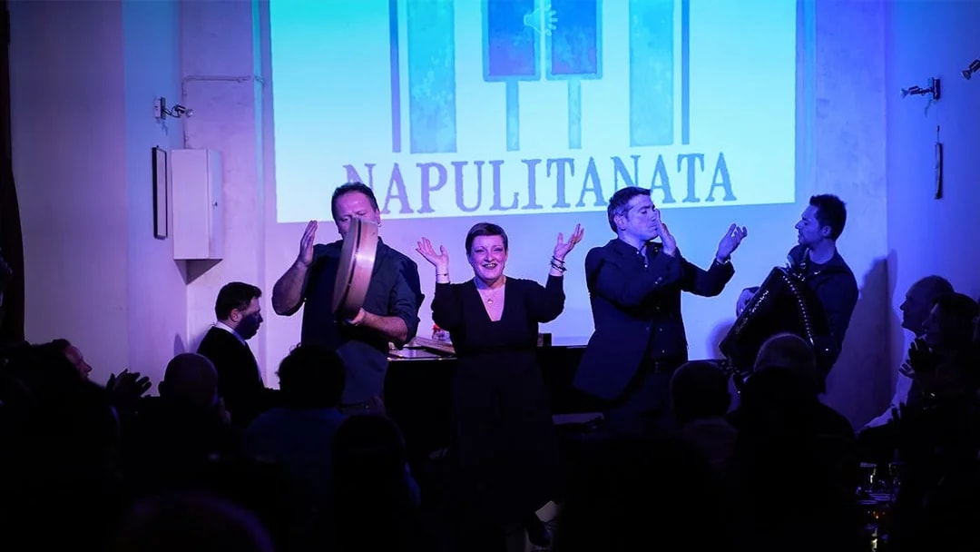 Traditional Neapolitan music concert with performers on stage in Naples, Italy.