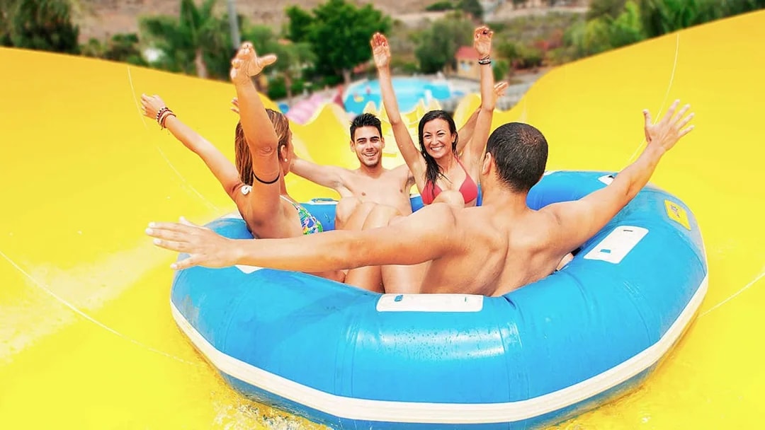 Group enjoying a water slide ride at Aqualand Maspalomas.
