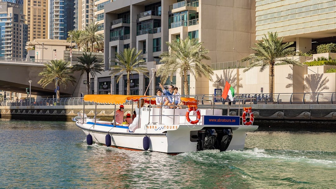 Dubai Marina cruise boat with tourists enjoying the Atlantis Scenic Cruise.
