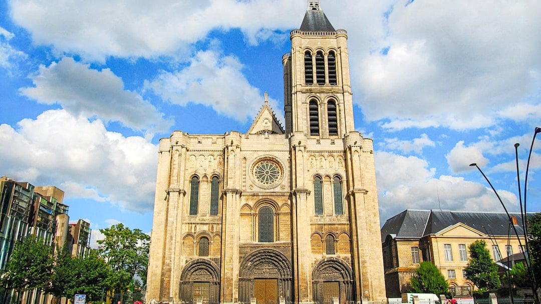 Basilica of Saint-Denis facade under blue sky, Paris, France.