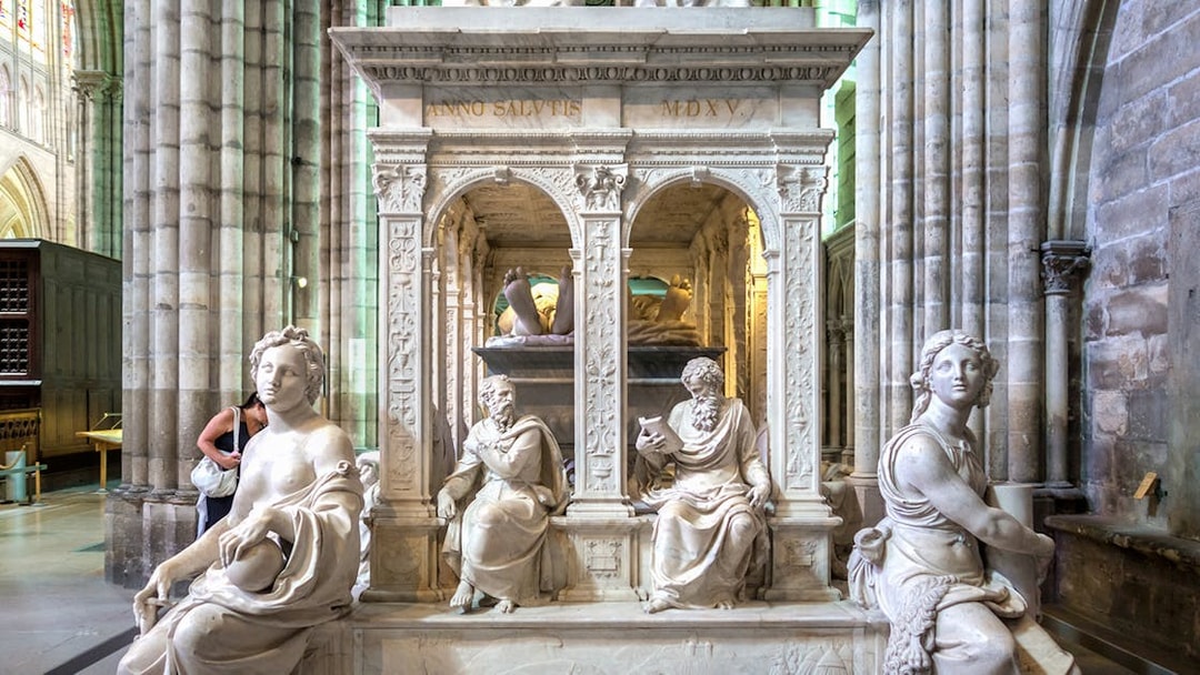 Sculptures inside Saint-Denis Basilica, Paris, showcasing intricate stone carvings.