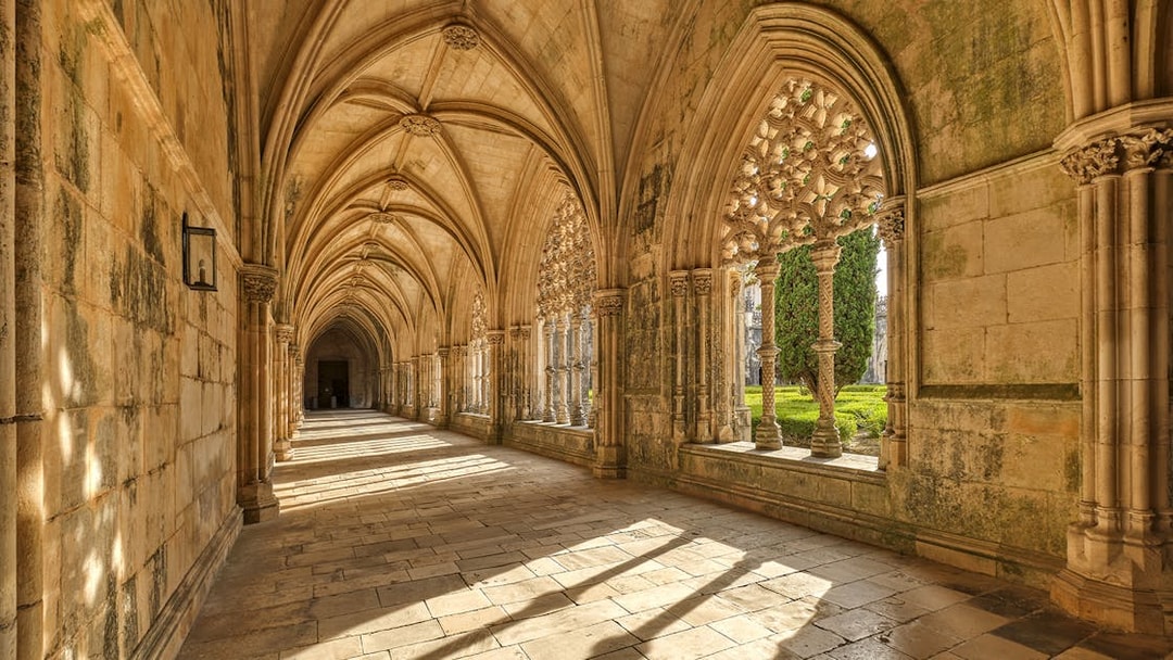 Cloister arches and stone columns at Batalha Monastery, Portugal.