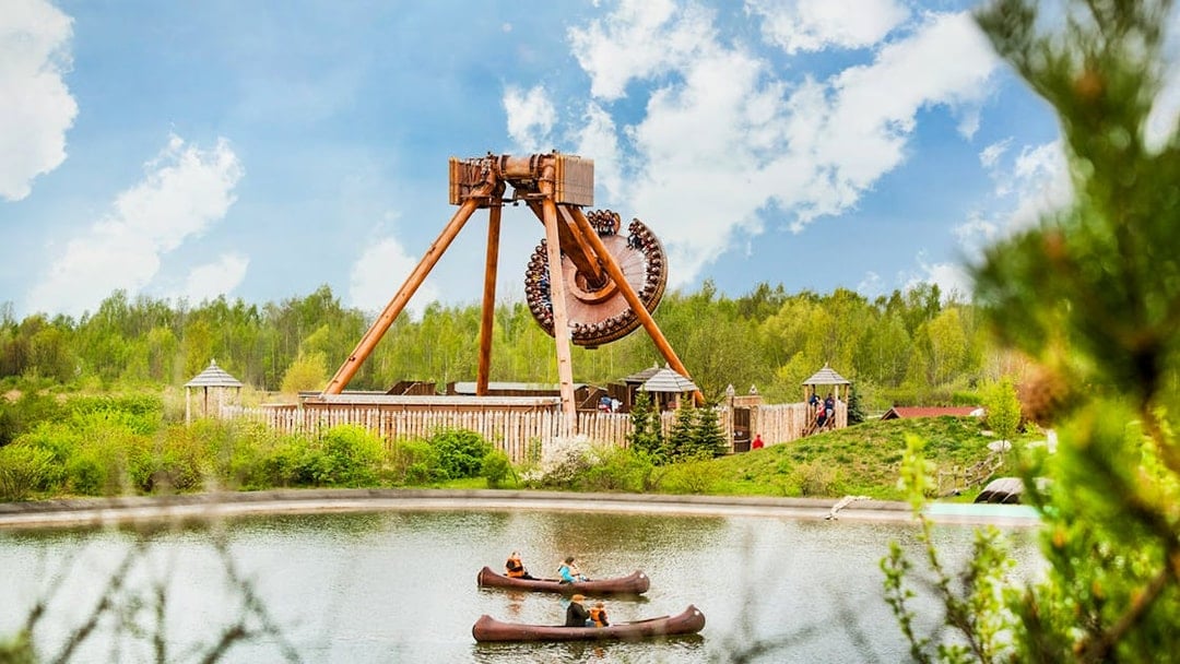 Belantis Adventure Park ride with canoes on a lake in the foreground.