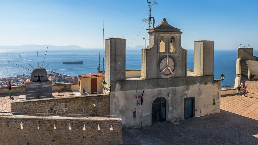 Castel Sant'Elmo terrace with clock tower and sea view, Naples, Italy.