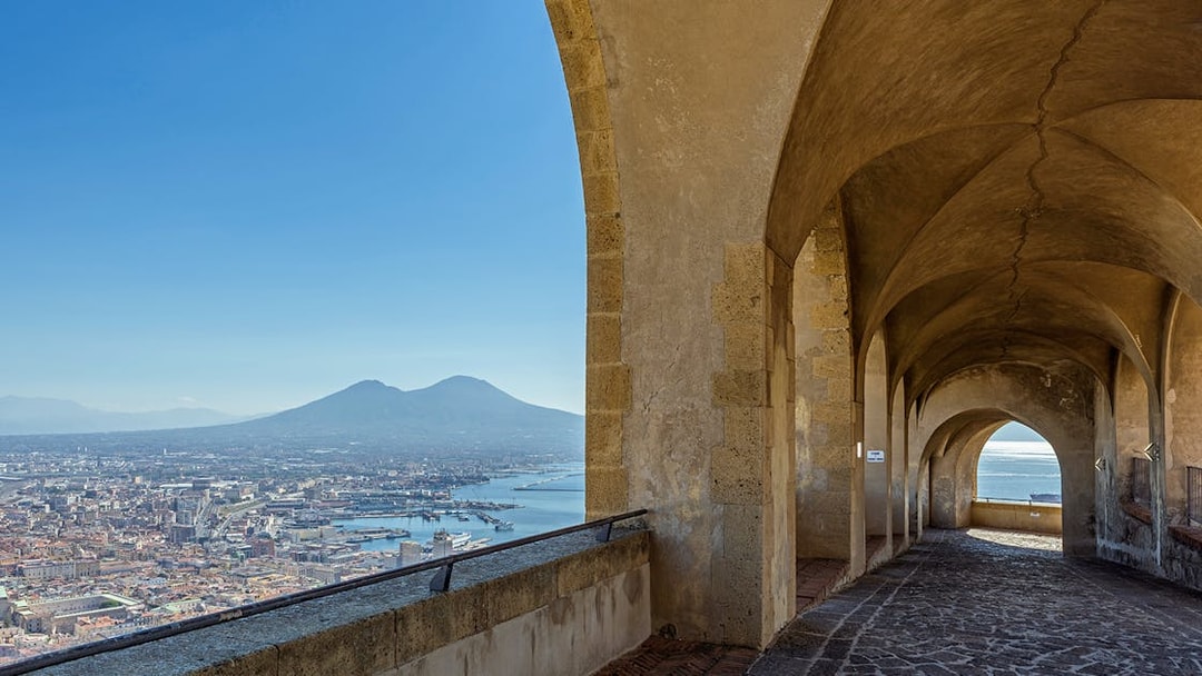 Arched walkway at Castel Sant'Elmo overlooking Naples and Mount Vesuvius.